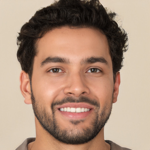 Joyful white young-adult male with short  black hair and brown eyes