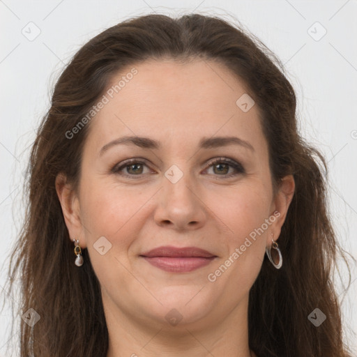 Joyful white adult female with long  brown hair and grey eyes