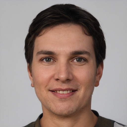 Joyful white young-adult male with short  brown hair and brown eyes