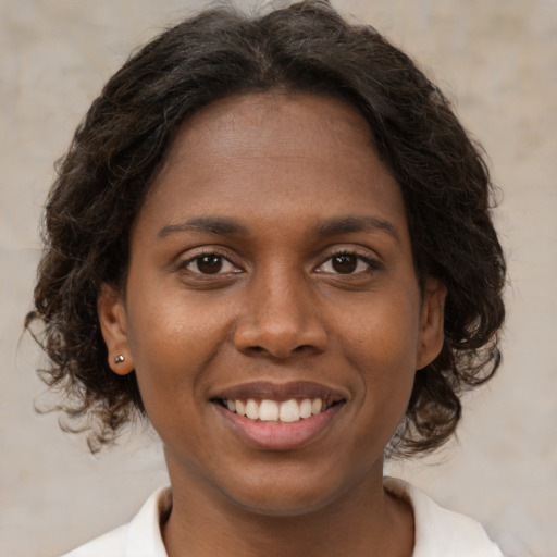 Joyful black young-adult female with medium  brown hair and brown eyes
