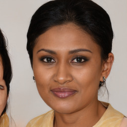 Joyful black young-adult female with medium  brown hair and brown eyes