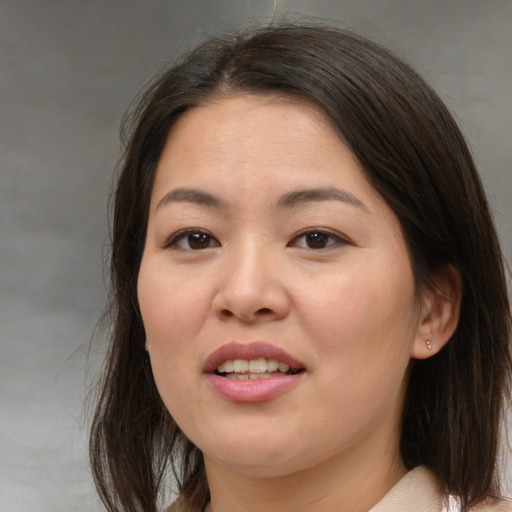 Joyful asian young-adult female with medium  brown hair and brown eyes