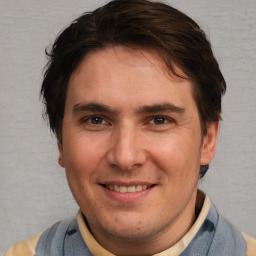 Joyful white adult male with short  brown hair and brown eyes