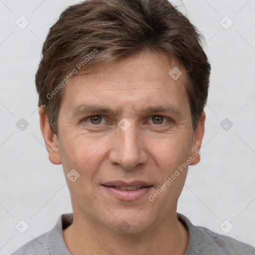 Joyful white adult male with short  brown hair and grey eyes