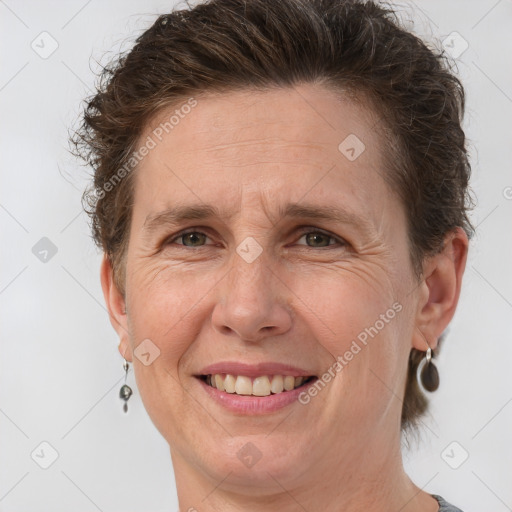 Joyful white adult female with short  brown hair and brown eyes