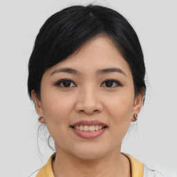 Joyful asian young-adult female with medium  black hair and brown eyes