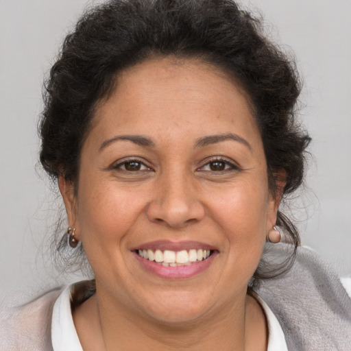 Joyful white adult female with short  brown hair and brown eyes