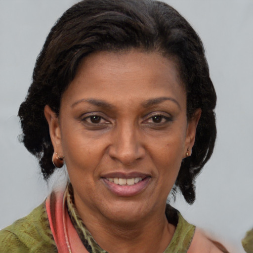 Joyful black adult female with short  brown hair and brown eyes