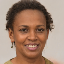 Joyful black adult female with short  brown hair and brown eyes