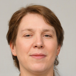 Joyful white adult female with medium  brown hair and grey eyes