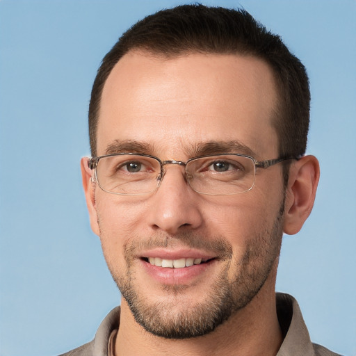 Joyful white adult male with short  brown hair and brown eyes