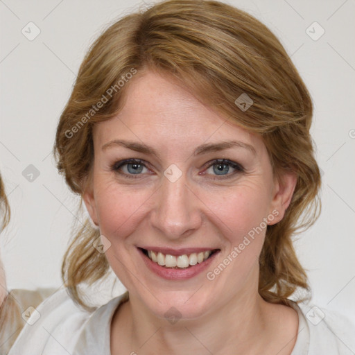 Joyful white young-adult female with medium  brown hair and blue eyes