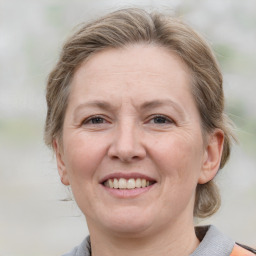 Joyful white adult female with medium  brown hair and grey eyes