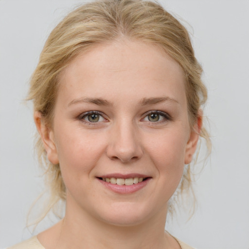 Joyful white young-adult female with medium  brown hair and blue eyes