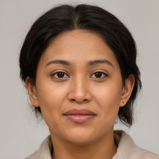 Joyful latino young-adult female with medium  brown hair and brown eyes
