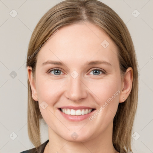 Joyful white young-adult female with long  brown hair and grey eyes