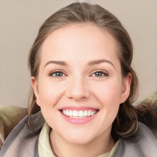 Joyful white young-adult female with medium  brown hair and grey eyes