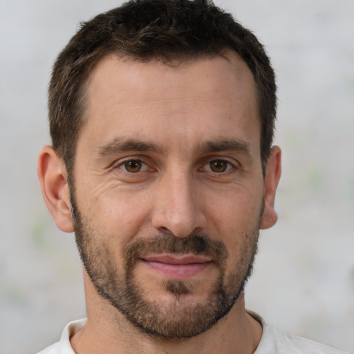 Joyful white adult male with short  brown hair and brown eyes