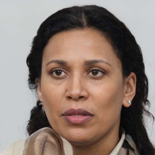 Joyful latino adult female with long  black hair and brown eyes