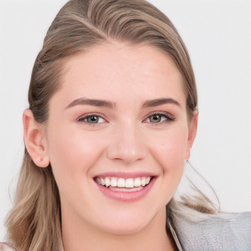 Joyful white young-adult female with medium  brown hair and blue eyes