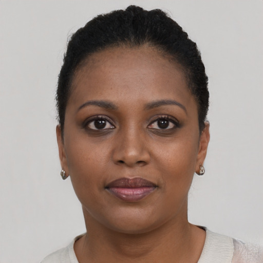 Joyful black young-adult female with short  brown hair and brown eyes