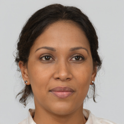 Joyful black adult female with medium  brown hair and brown eyes