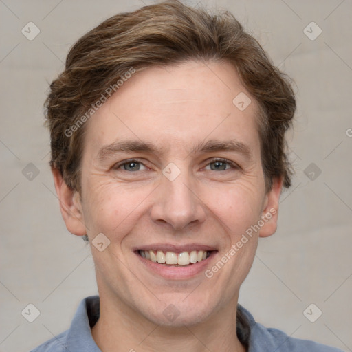 Joyful white adult male with short  brown hair and grey eyes