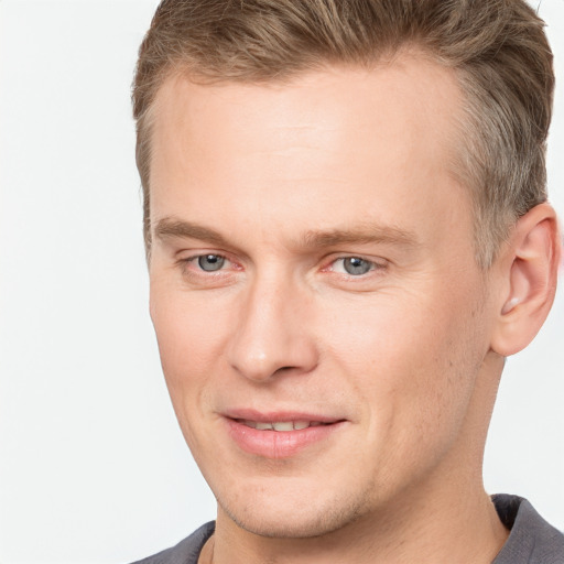 Joyful white adult male with short  brown hair and brown eyes