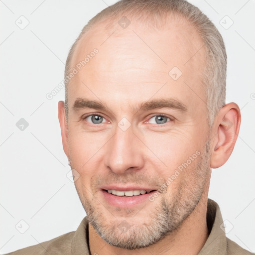 Joyful white adult male with short  brown hair and grey eyes