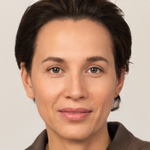 Joyful white adult female with medium  brown hair and brown eyes