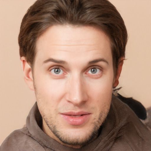 Joyful white young-adult male with short  brown hair and grey eyes