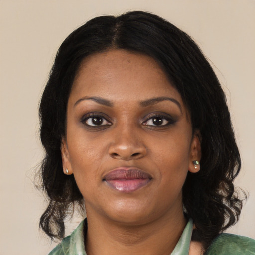 Joyful black young-adult female with medium  black hair and brown eyes