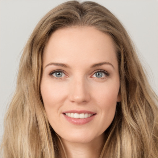 Joyful white young-adult female with long  brown hair and grey eyes