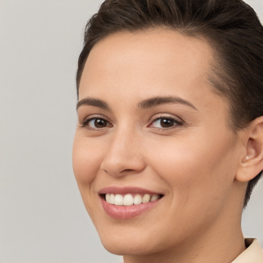 Joyful white young-adult female with short  brown hair and brown eyes