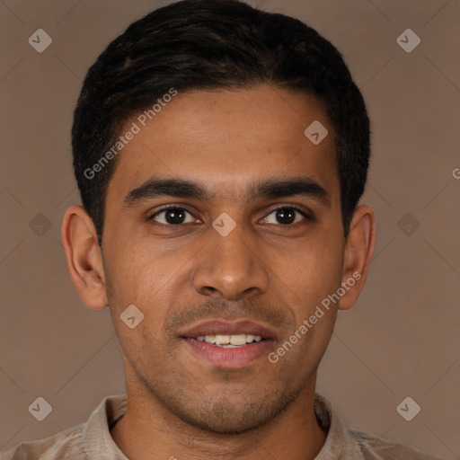 Joyful latino young-adult male with short  brown hair and brown eyes