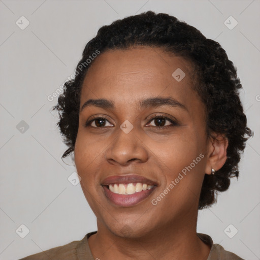 Joyful black young-adult female with short  black hair and brown eyes