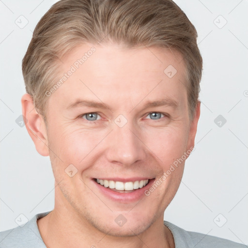 Joyful white young-adult male with short  brown hair and blue eyes