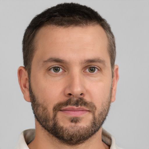 Joyful white young-adult male with short  brown hair and brown eyes