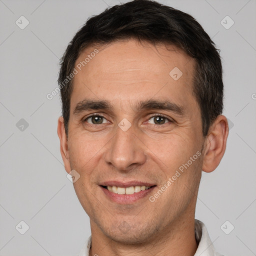 Joyful white adult male with short  brown hair and brown eyes