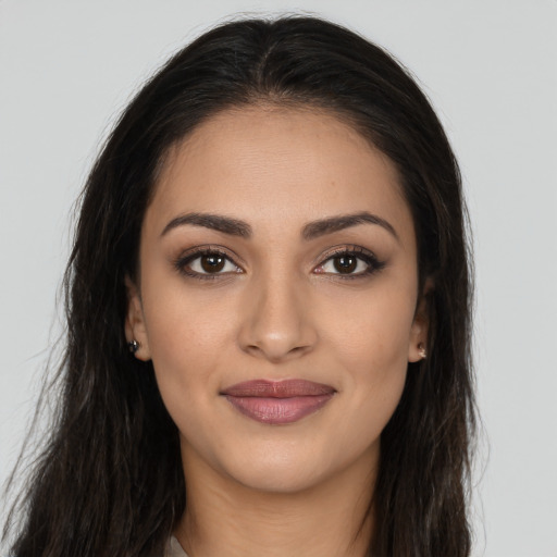 Joyful latino young-adult female with long  brown hair and brown eyes