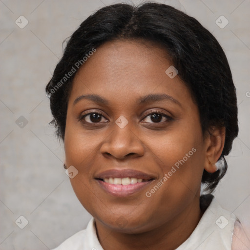 Joyful black adult female with short  brown hair and brown eyes