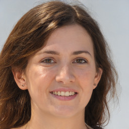 Joyful white adult female with medium  brown hair and brown eyes