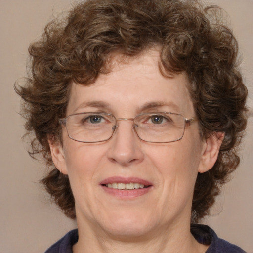 Joyful white adult female with medium  brown hair and blue eyes