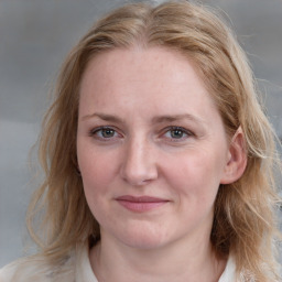 Joyful white young-adult female with medium  brown hair and blue eyes