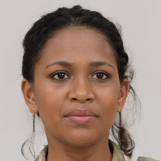 Joyful black young-adult female with medium  brown hair and brown eyes