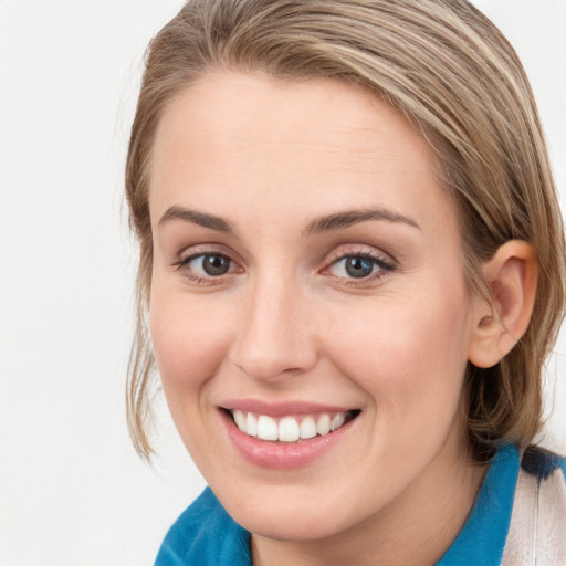 Joyful white young-adult female with long  brown hair and blue eyes