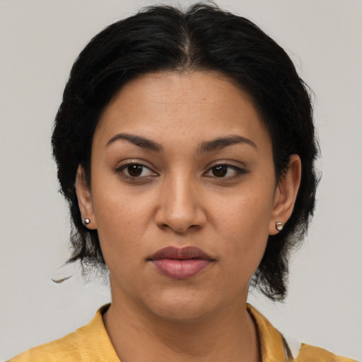 Joyful latino young-adult female with medium  brown hair and brown eyes
