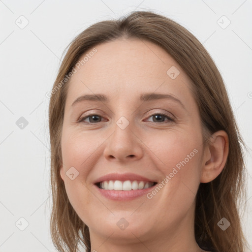 Joyful white young-adult female with long  brown hair and grey eyes