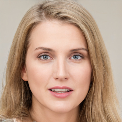 Joyful white young-adult female with long  brown hair and blue eyes