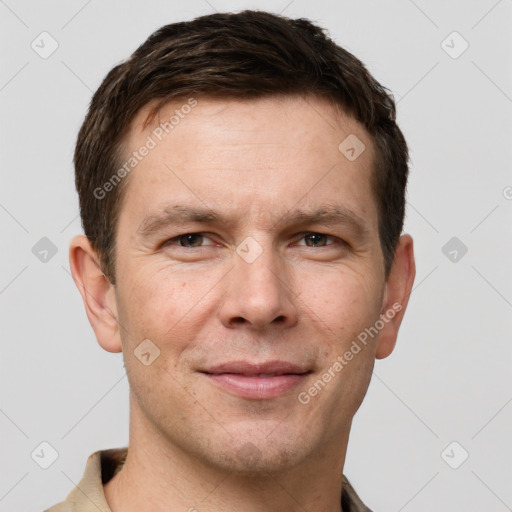 Joyful white adult male with short  brown hair and grey eyes